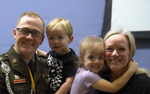 Army Staff Sergeant 1 Crum poses with family following awards ceremony