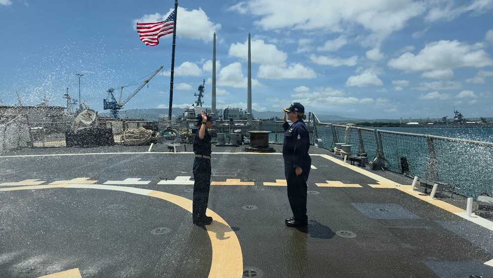 U.S. Navy sailors render honors during colors ceremony aboard warship at Pearl Harbor
