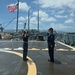 U.S. Navy sailors render honors during colors ceremony aboard warship at Pearl Harbor