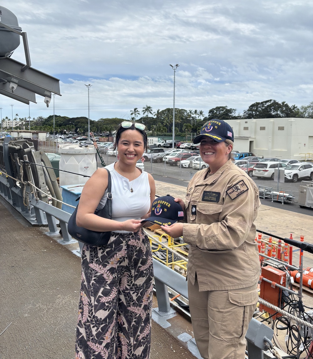 USS Hopper Sailor Presents Ship's Ball Cap to Civilian Visitor at Pearl Harbor