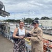 USS Hopper Sailor Presents Ship's Ball Cap to Civilian Visitor at Pearl Harbor