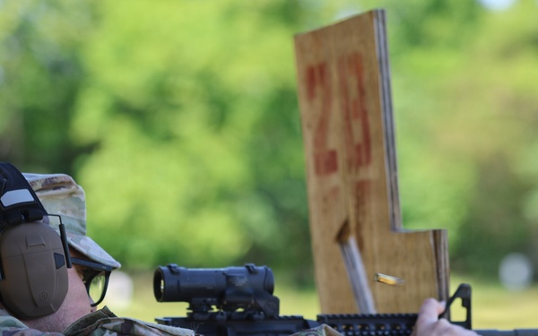 Soldier fires M4 carbine during Promotion Ceremony