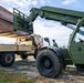 NMCB 1 Sailors and U.S. Airmen load wood cargo for roof restoration operations
