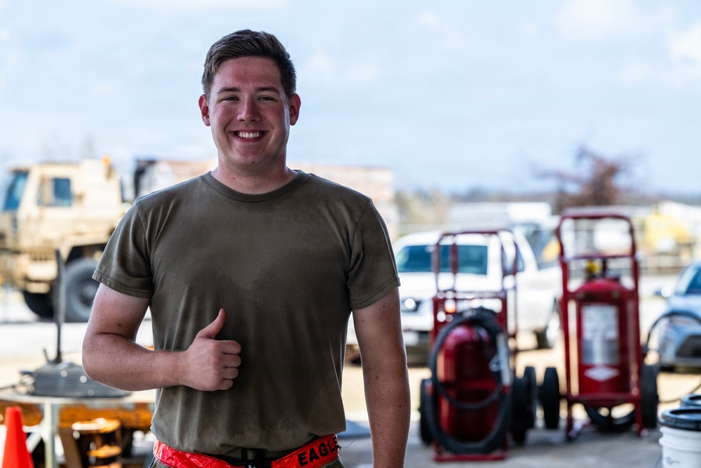 NMCB 1 Sailors and U.S. Airmen load wood cargo for roof restoration operations