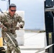 NMCB 1 Sailors and U.S. Airmen load wood cargo for roof restoration operations