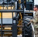 NMCB 1 Sailors and U.S. Airmen load wood cargo for roof restoration operations
