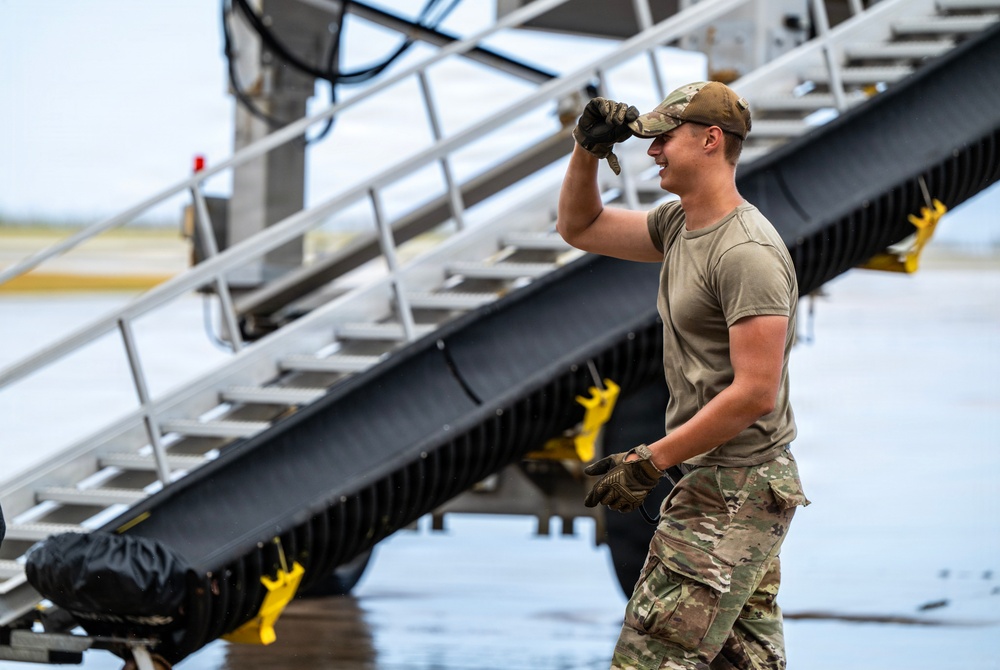 NMCB 1 Sailors and U.S. Airmen load wood cargo for roof restoration operations