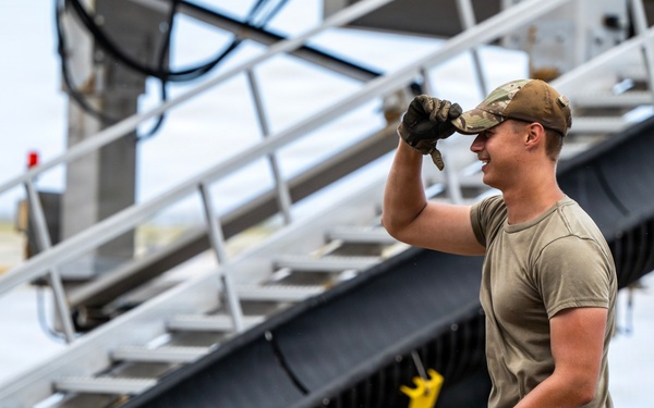 NMCB 1 Sailors and U.S. Airmen load wood cargo for roof restoration operations