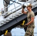 NMCB 1 Sailors and U.S. Airmen load wood cargo for roof restoration operations