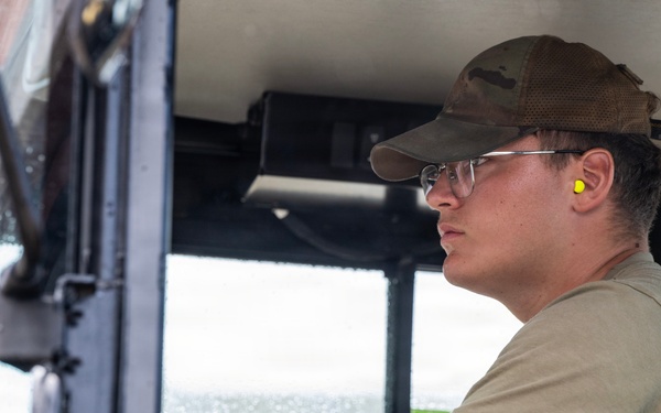 NMCB 1 Sailors and U.S. Airmen load wood cargo for roof restoration operations