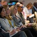 Military and civilian attendees listen to speakers at ABID