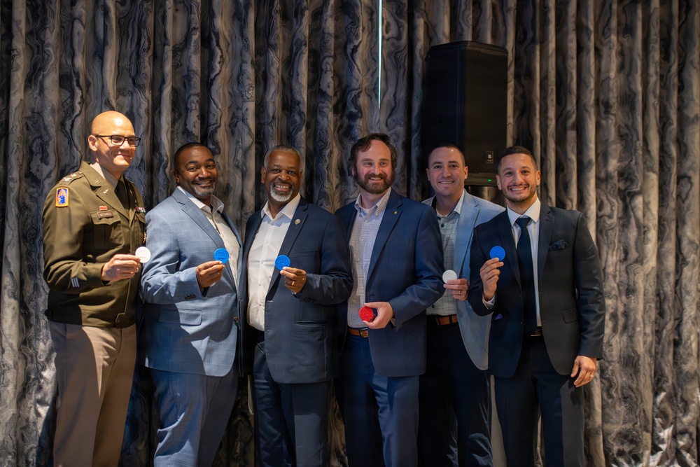 Army Officer and Civilian Leaders Pose with Challenge Coins at ABID 2026
