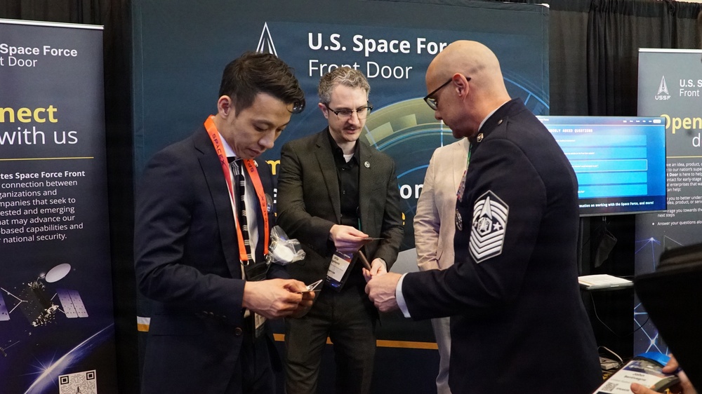 Chief Master Sgt. of the Space Force John F. Bentivegna meets with Space Force Front Door Director Victor Vigliotti and Aerospace’s Joseph Whang during Space Symposium