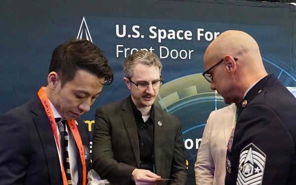 Chief Master Sgt. of the Space Force John F. Bentivegna meets with Space Force Front Door Director Victor Vigliotti and Aerospace’s Joseph Whang during Space Symposium