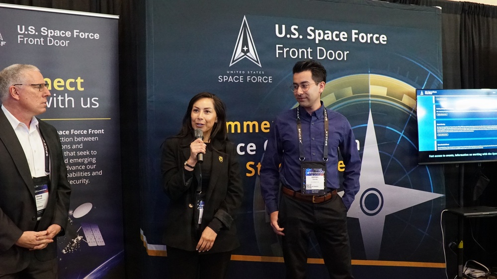 Blanca Nuno and Adrian Torres speak to attendees during Space Symposium