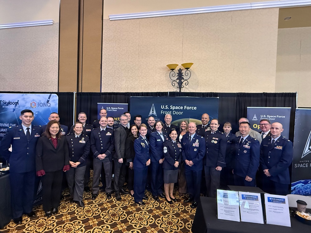 The Space Systems Command leadership team gathers at the Front Door Booth during Space Symposium