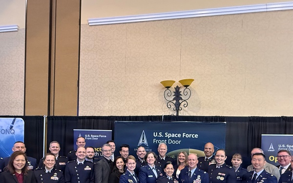 The Space Systems Command leadership team gathers at the Front Door Booth during Space Symposium
