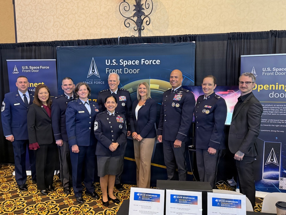 The Space Systems Command leadership team gathers at the Front Door Booth during Space Symposium