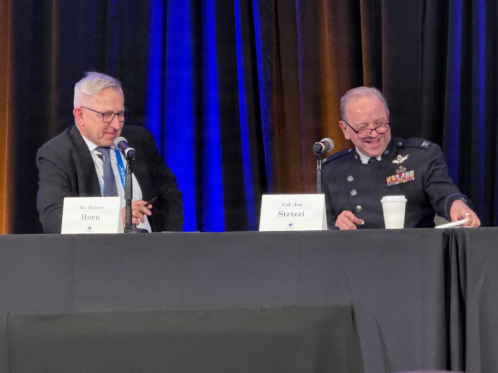 Moderator Rainer Horn interviews Col. Jon Strizzi at Space Symposium