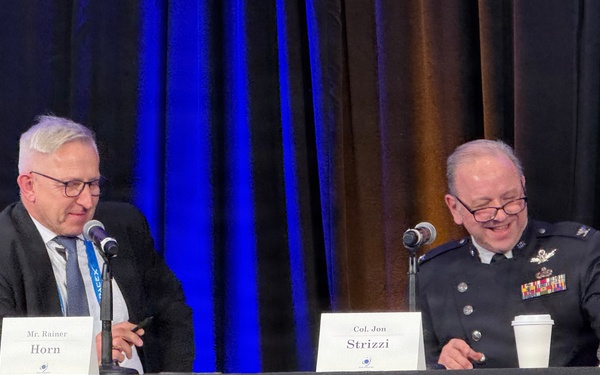 Moderator Rainer Horn interviews Col. Jon Strizzi at Space Symposium