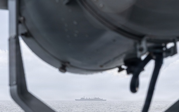USS Mustin conducts a replenishment-at-sea with USNS Arctic
