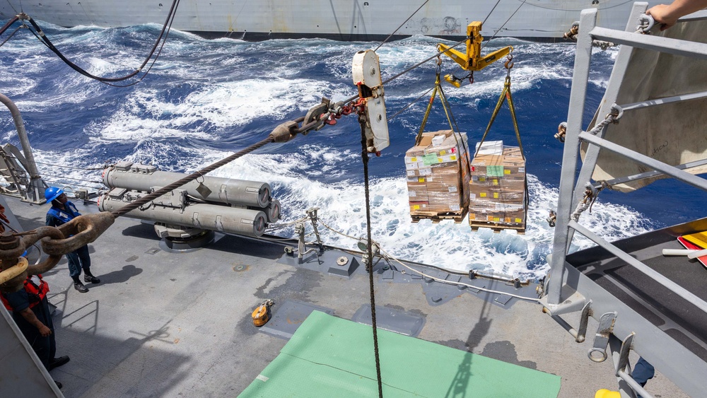 USS Mustin conducts a replenishment-at-sea with USNS Arctic