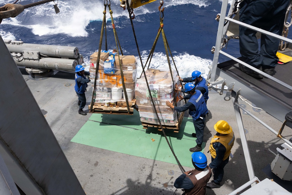 USS Mustin conducts a replenishment-at-sea with USNS Arctic