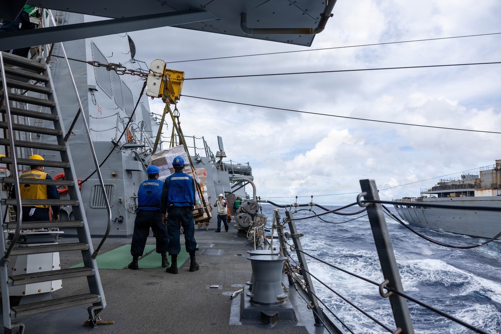 USS Mustin conducts a replenishment-at-sea with USNS Arctic