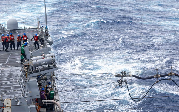 USS Mustin conducts a replenishment-at-sea with USNS Arctic