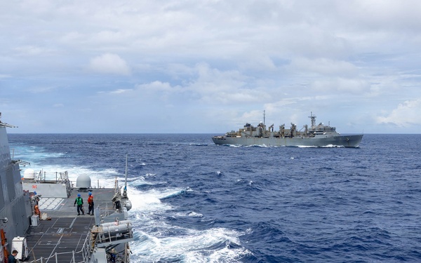 USS Mustin conducts a replenishment-at-sea with USNS Arctic