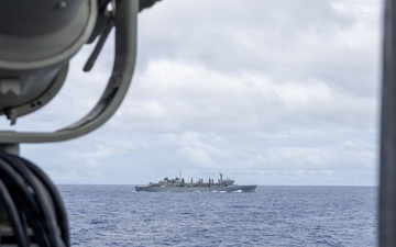 USS Mustin conducts a replenishment-at-sea with USNS Arctic