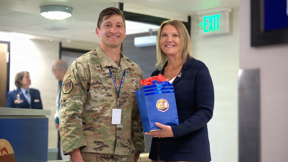 Natalie Riedel presents Cadet Squadron 9 with a flag flown in space