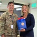 Natalie Riedel presents Cadet Squadron 9 with a flag flown in space