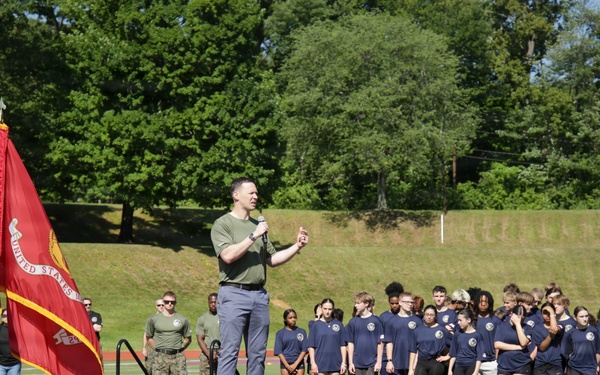 Mr. Tim Dill, assistant secretary of War for manpower and reserve affairs, addresses DoWEA students, parents, staff and Marines during the Presidential Physical Fitness Test