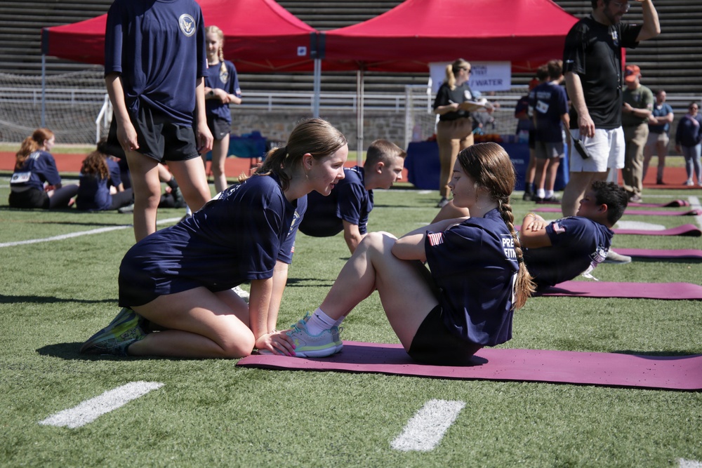 DoWEA Quantico Middle High School students perform curl-ups during the Presidential Physical Fitness Test