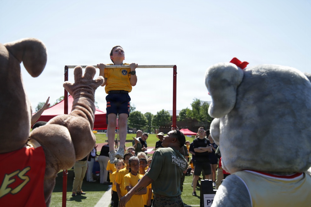 DoWEA Crossroads Elementary School student performs pull-ups during the Presidential Physical Fitness Test