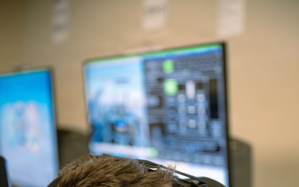 Student Naval Aviator Trains Using Virtual Reality Simulator