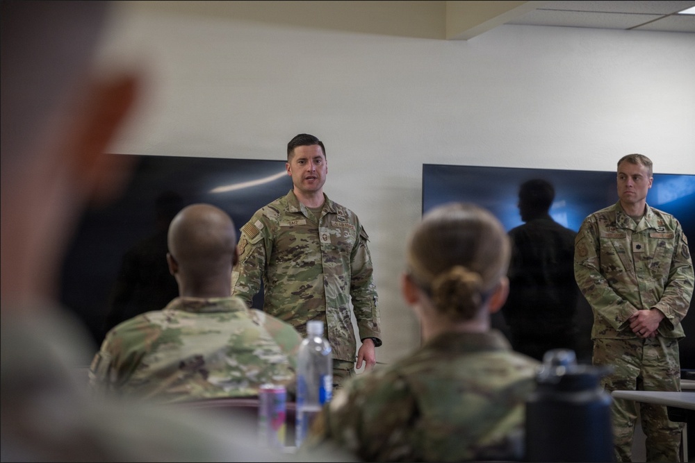 Senior Master Sgt. Gavin Saiz, 377 SFS senior enlisted leader, congratulate graduates of the inaugural Entry Controller Leaders Course during a graduation ceremony.