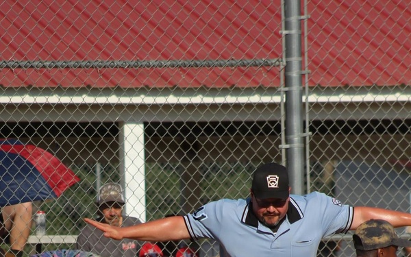 Umpire Signals Safe as Runner Slides Into Home Plate During Youth Baseball Game