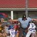 Umpire Signals Safe as Runner Slides Into Home Plate During Youth Baseball Game