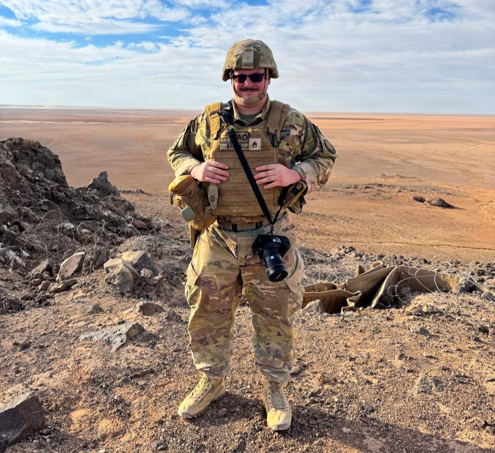 U.S. Army PAO Soldier poses at elevated desert outpost