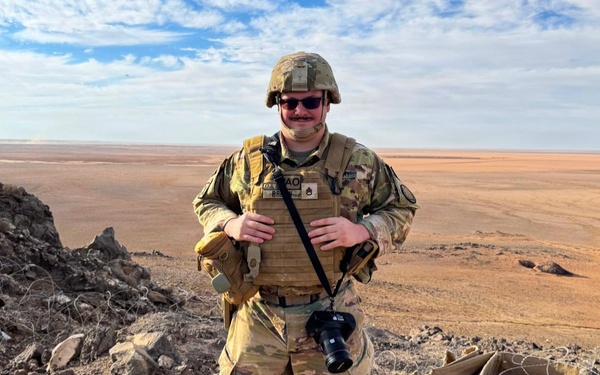 U.S. Army PAO Soldier poses at elevated desert outpost
