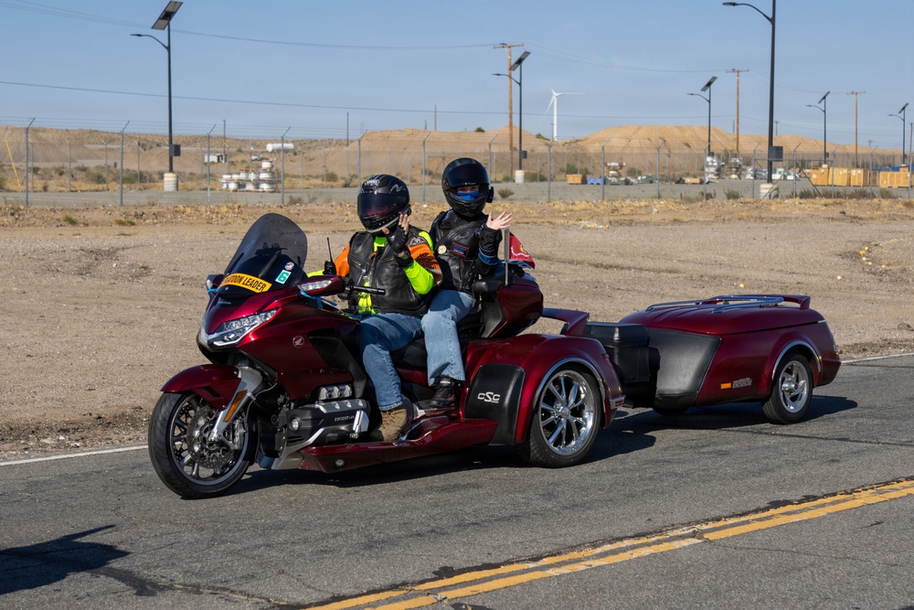 Marine and civilian personnel waved on veteran motorcycle riders with salutes and American flags along Route 66/Joseph L. Boll