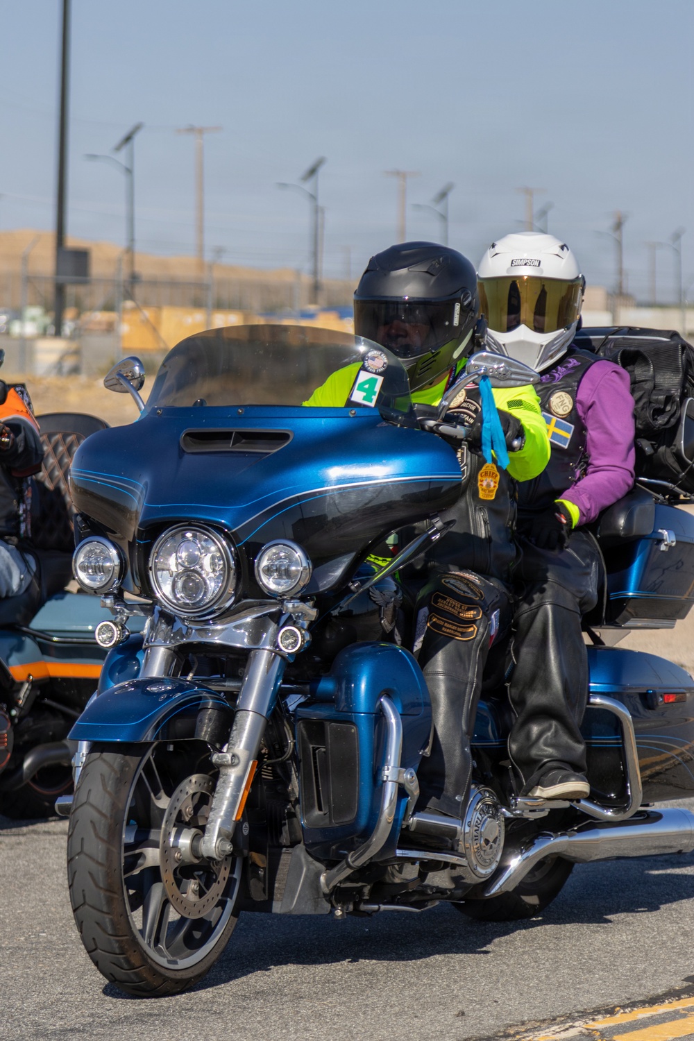Marine and civilian personnel waved on veteran motorcycle riders with salutes and American flags along Route 66/Joseph L. Boll