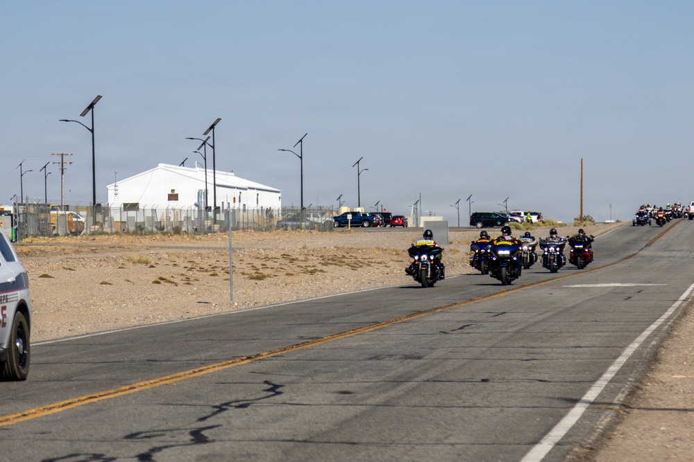 Marine and civilian personnel waved on veteran motorcycle riders with salutes and American flags along Route 66/Joseph L. Boll