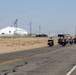 Marine and civilian personnel waved on veteran motorcycle riders with salutes and American flags along Route 66/Joseph L. Boll