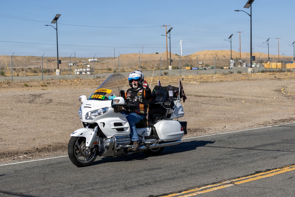 Marine and civilian personnel waved on veteran motorcycle riders with salutes and American flags along Route 66/Joseph L. Bol