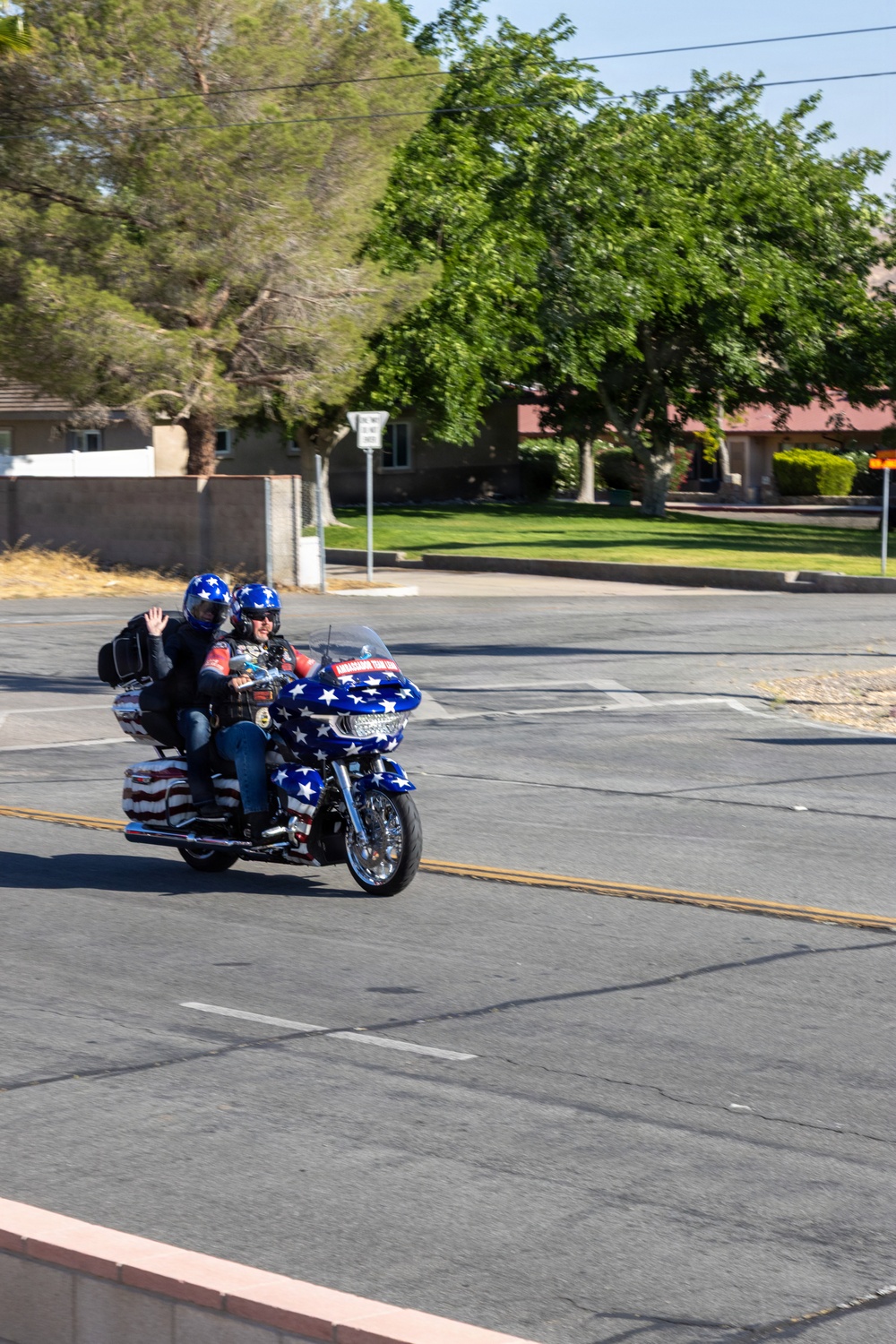 Marine and civilian personnel waved on veteran motorcycle riders with salutes and American flags along Route 66/Joseph L. Boll