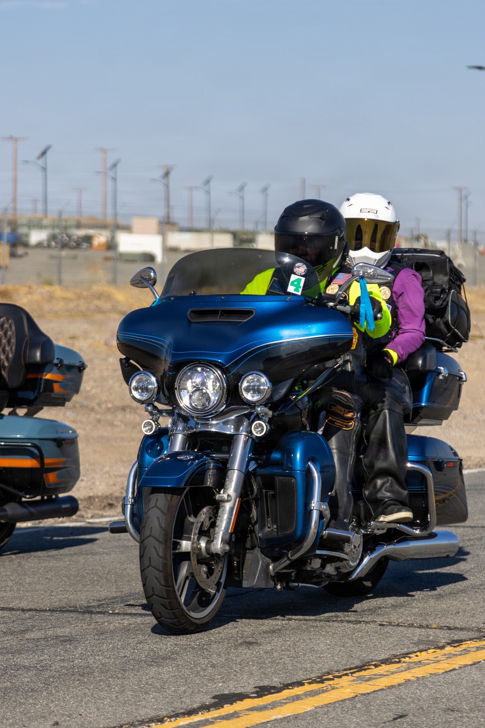 Marine and civilian personnel waved on veteran motorcycle riders with salutes and American flags along Route 66/Joseph L. Boll