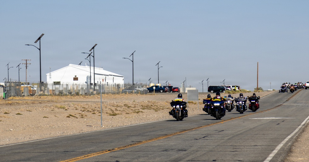 Marine and civilian personnel waved on veteran motorcycle riders with salutes and American flags along Route 66/Joseph L. Boll